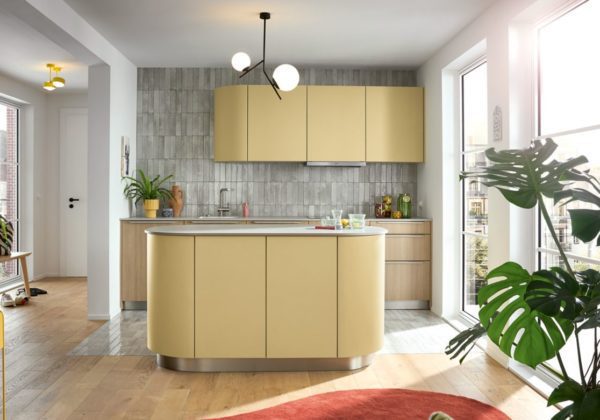 Unique pendent light shown in a small yellow kitchen