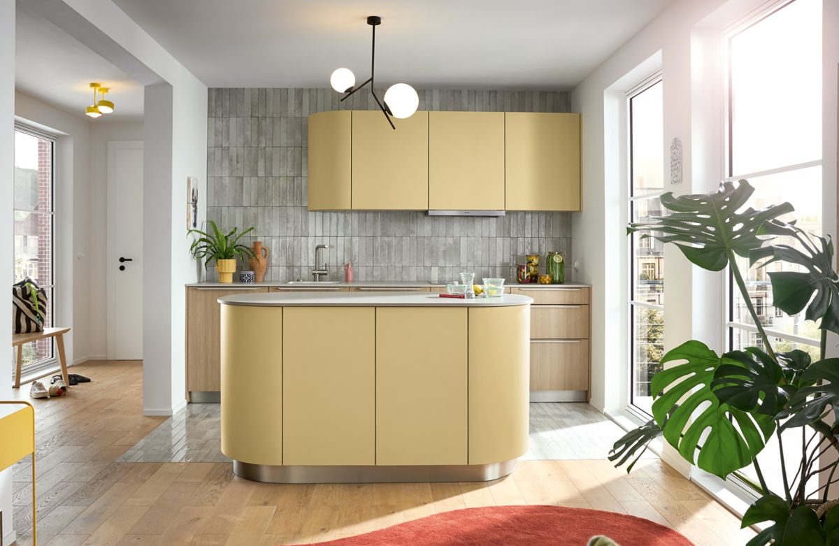 Unique pendent light shown in a small yellow kitchen